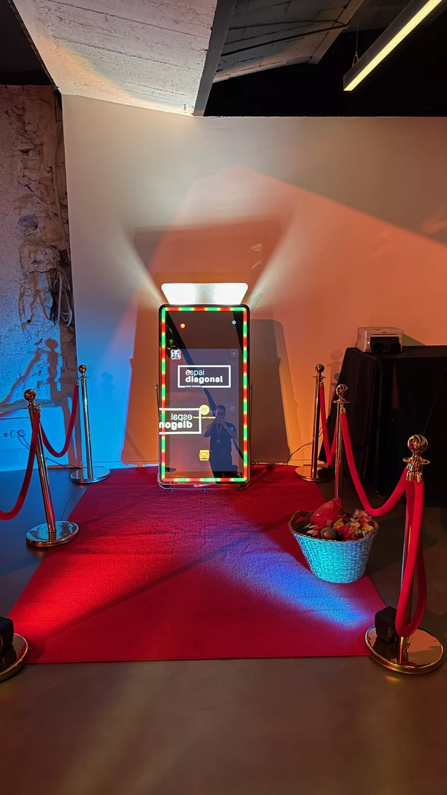 Magic mirror photo booth with an LED light frame, red carpet and rope barriers at the Espai Diagonal opening