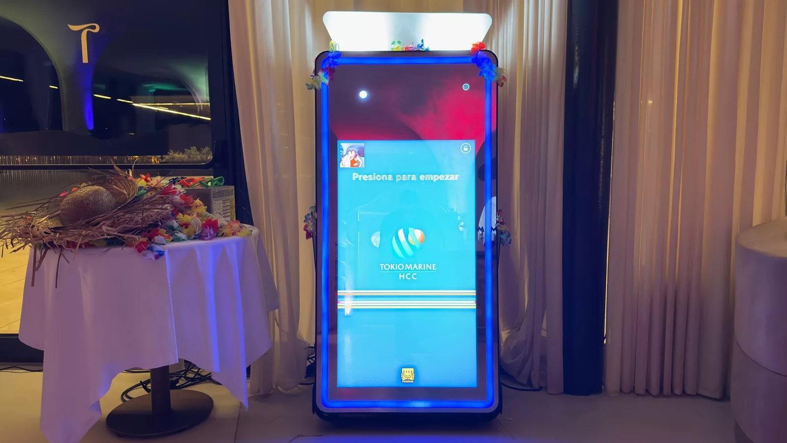Magic mirror photo booth with the Tokio Marine HCC branding on screen during a corporate dinner